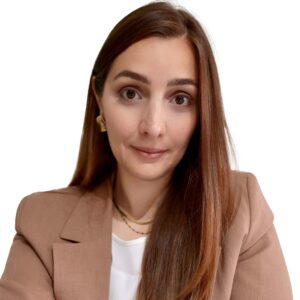 Professional headshot of a female marketing leader in a neutral setting wearing a beige blazer